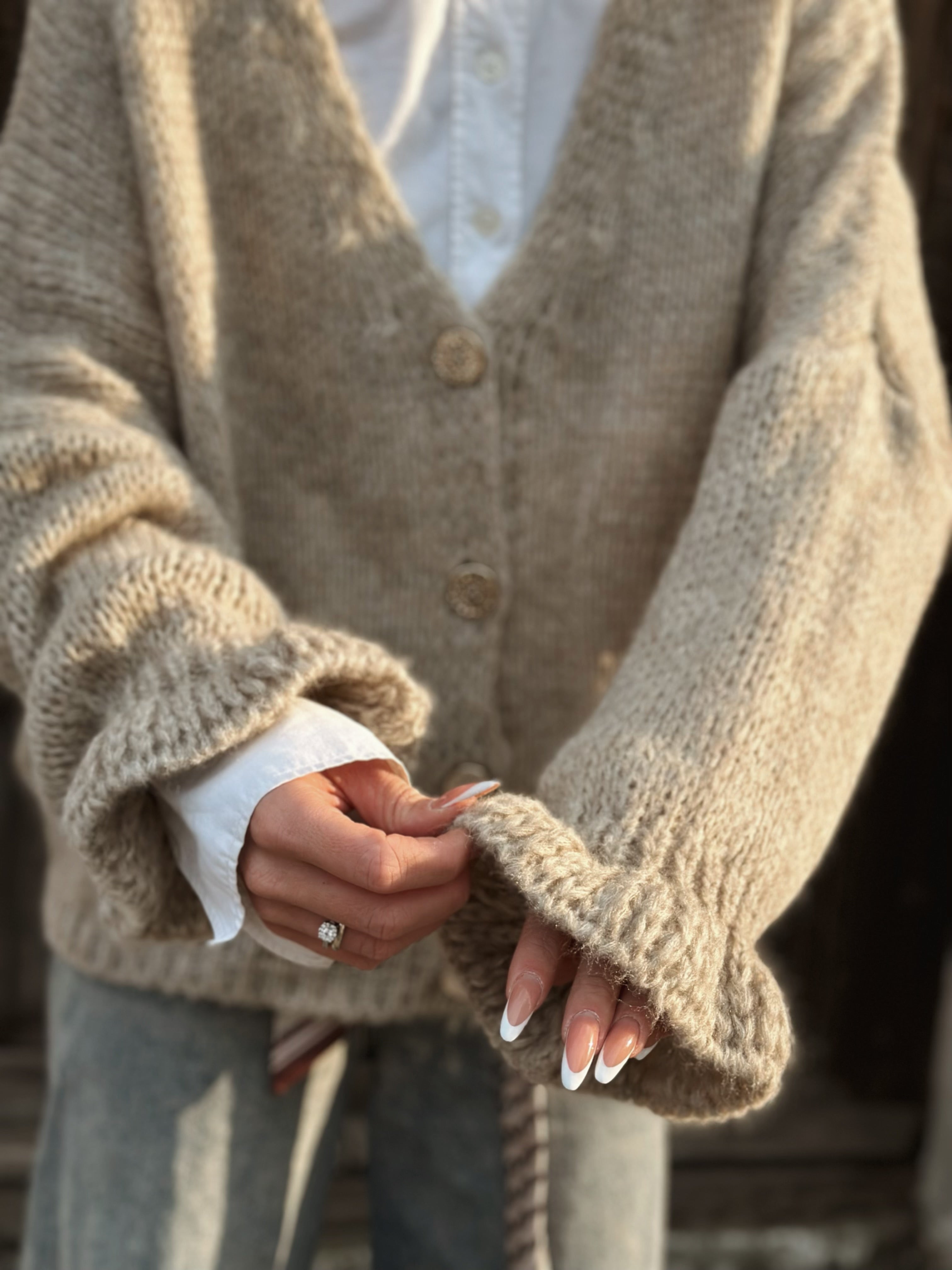 Stickad kofta med volangärm