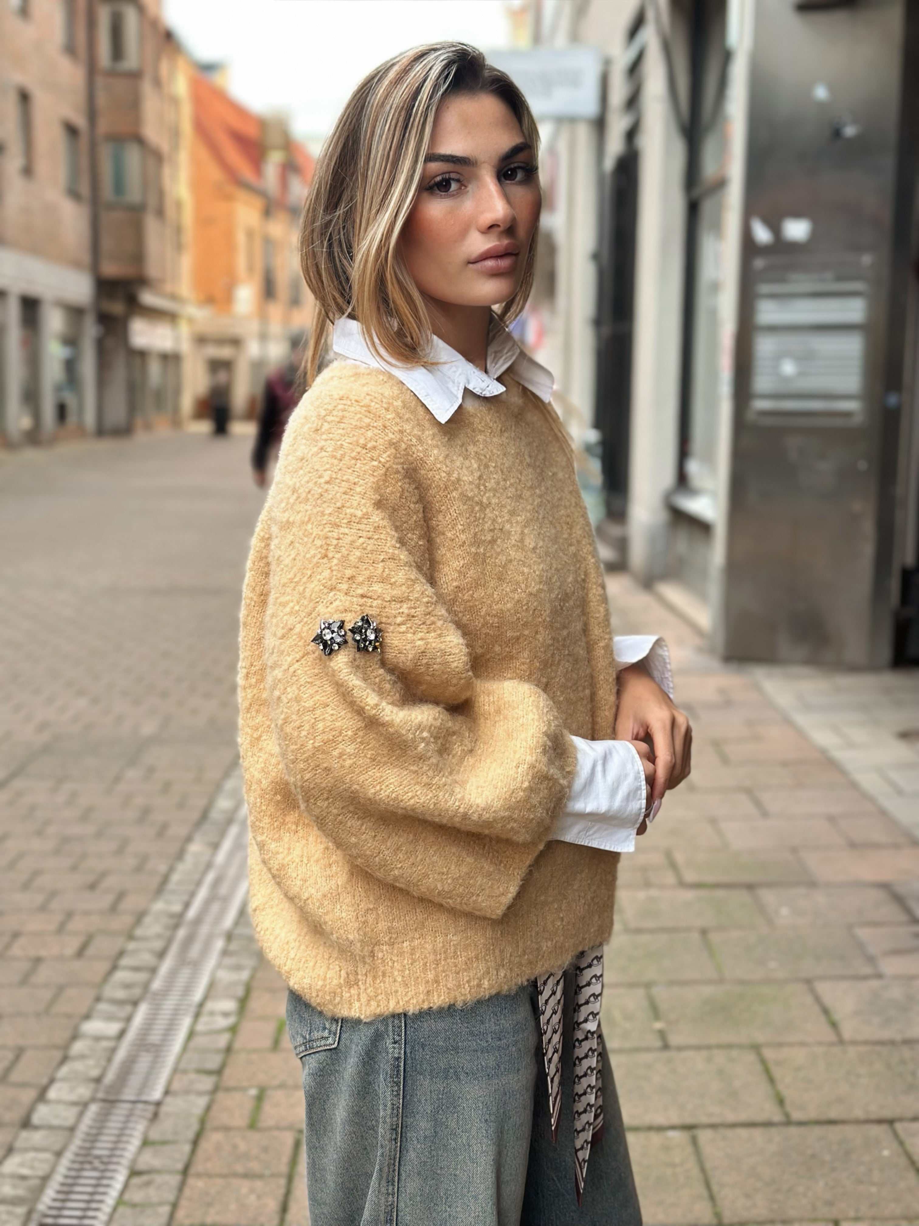 Stickad tröja med broschdetalj